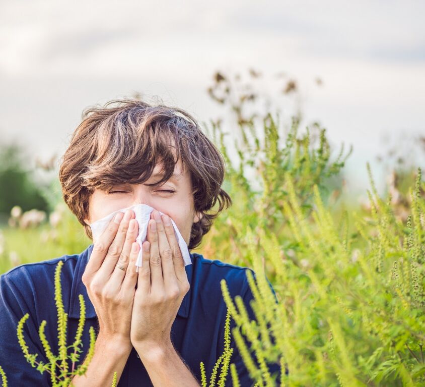 Boy sneezes because of an allergy about to get naturopathy treatment