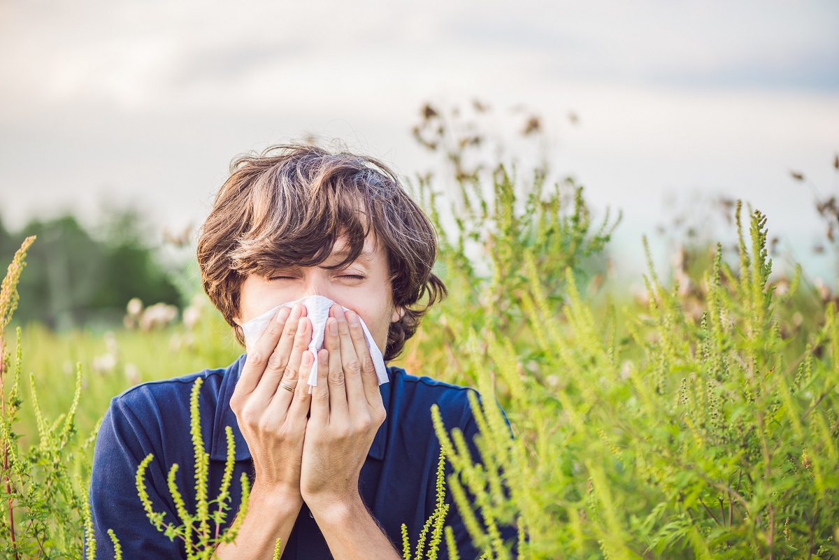 Boy sneezes because of an allergy about to get naturopathy treatment