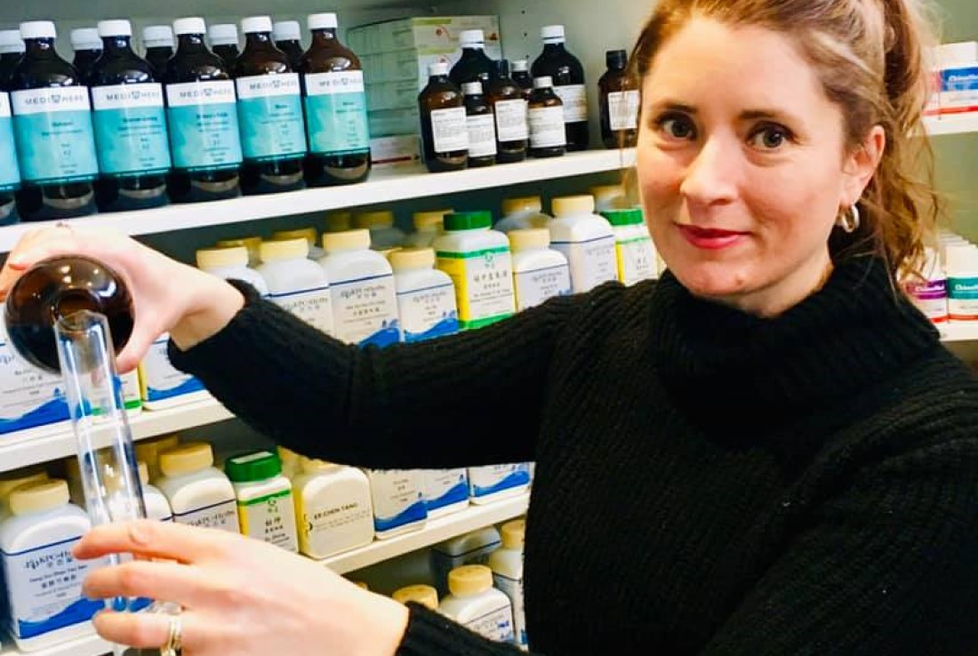 Our Practitioner Sallie pouring herbs to make Naturopathic Meds