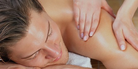 A man getting a back massage at a spa.