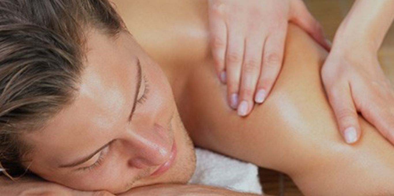 A man getting a back massage at a spa